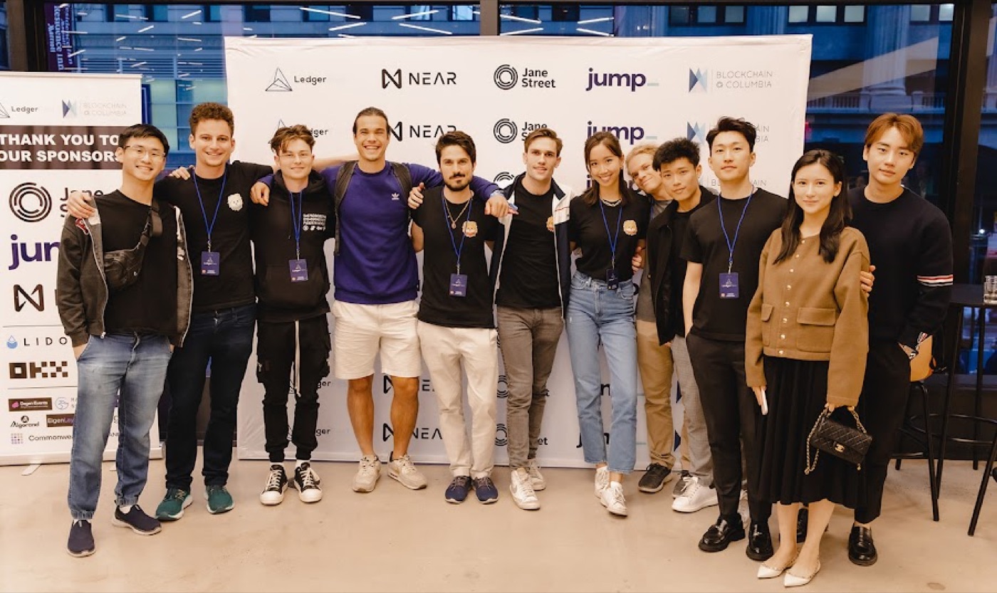 The Blockchain at Columbia crew in front of the sponsor wall