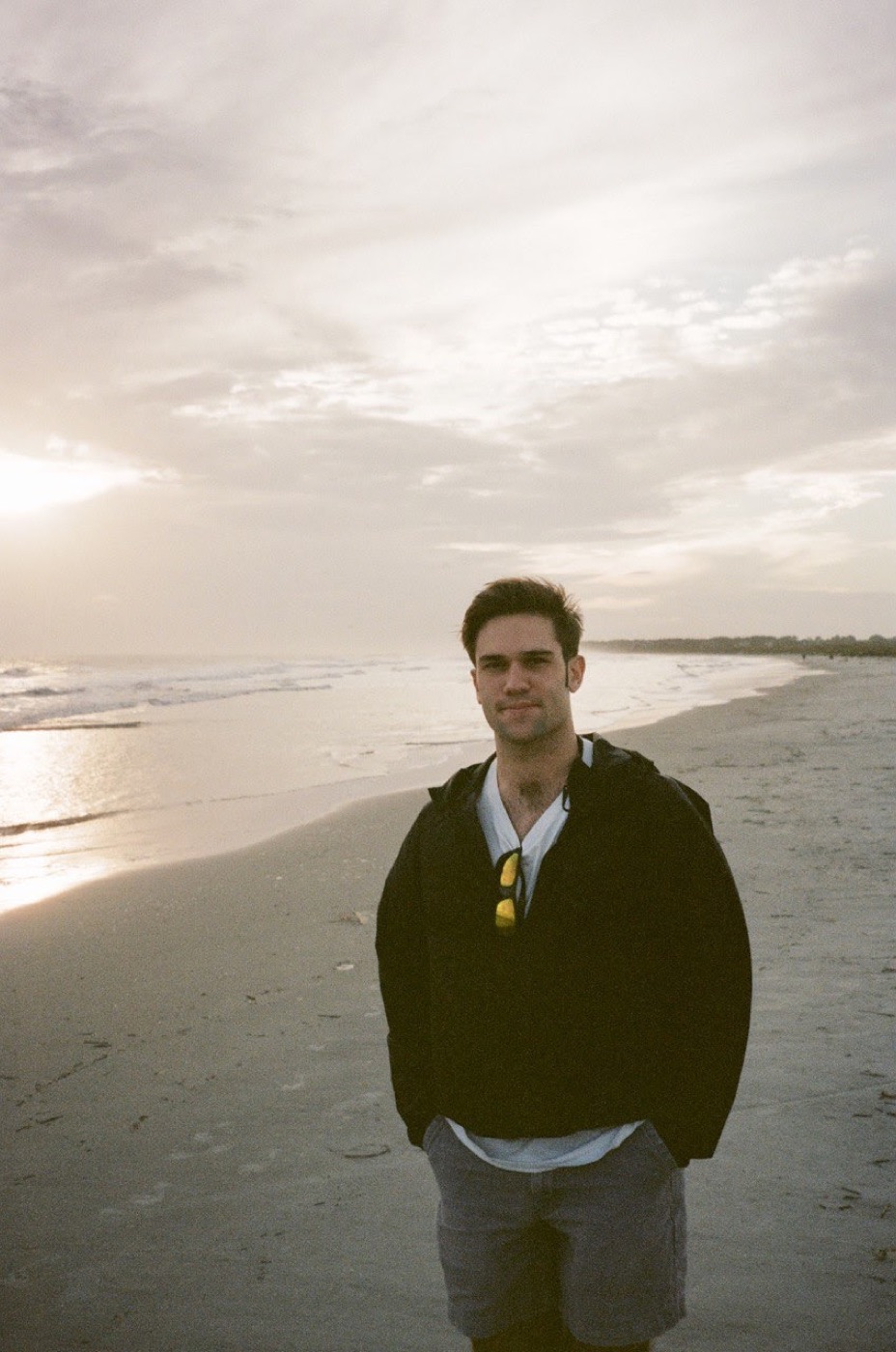 Noel on the beach, shot on film under a big pale sky