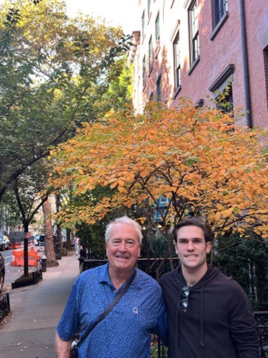 Father and son under golden fall foliage