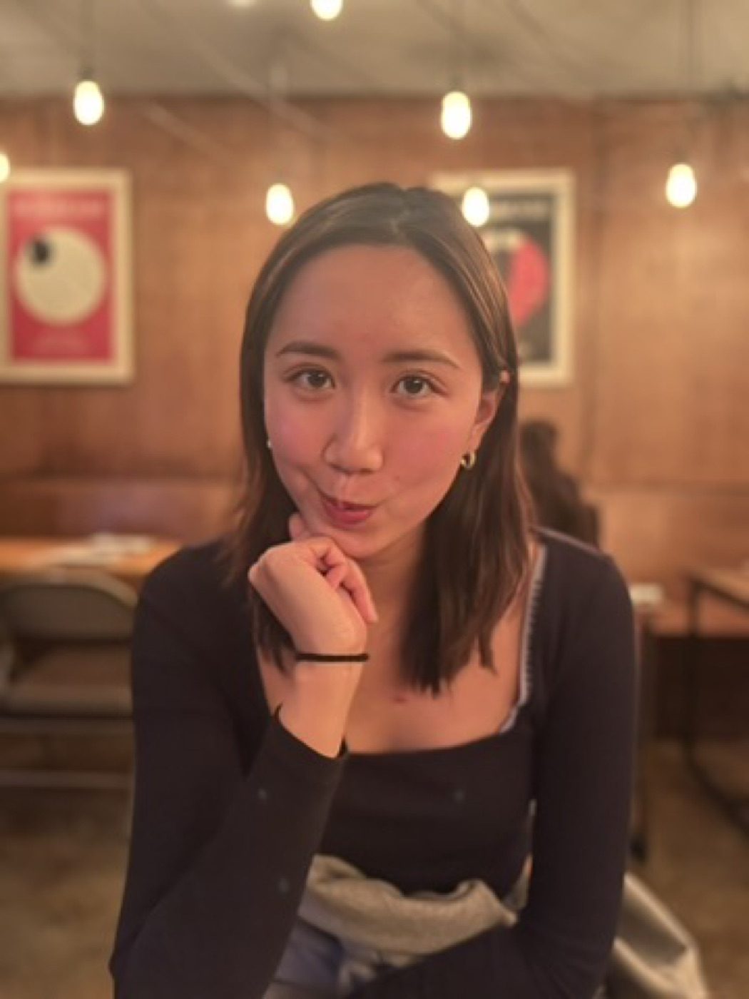 Playful warm-lit cafe portrait with bokeh