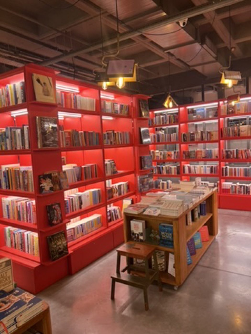 Red-shelved bookstore interior with receding depth