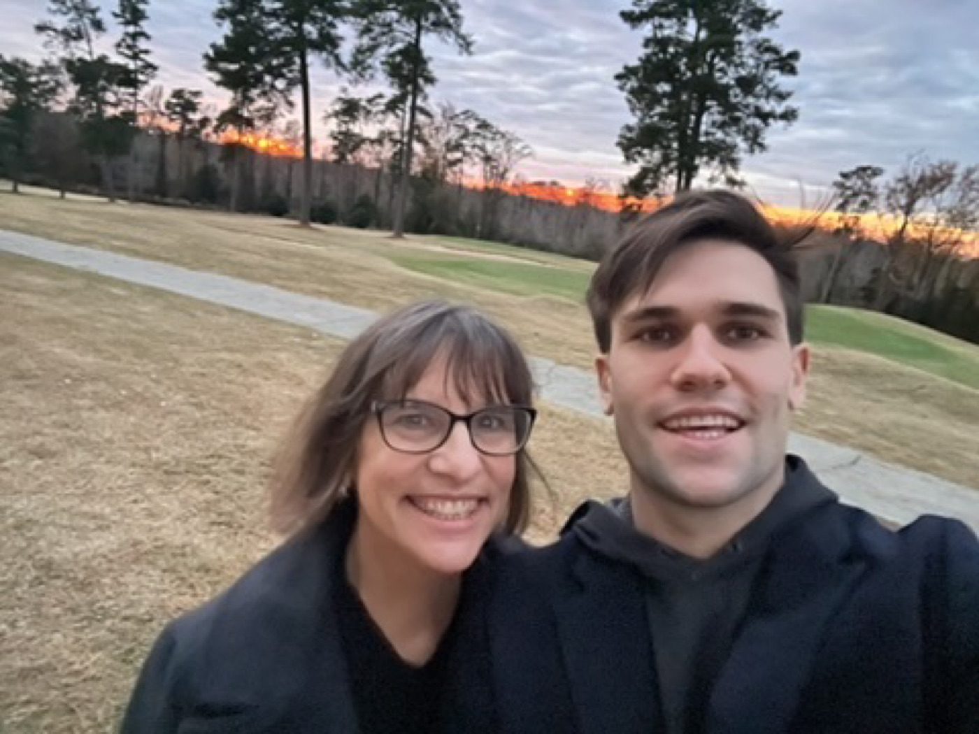 Golden-hour selfie with his mom on a quiet golf course