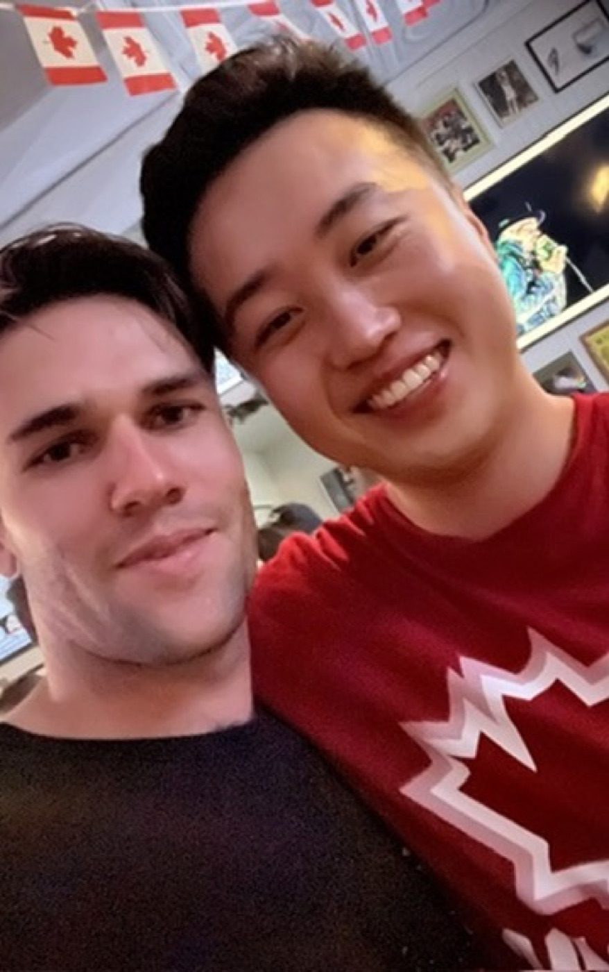 Grinning cheek-to-cheek selfie with a good friend at a bar