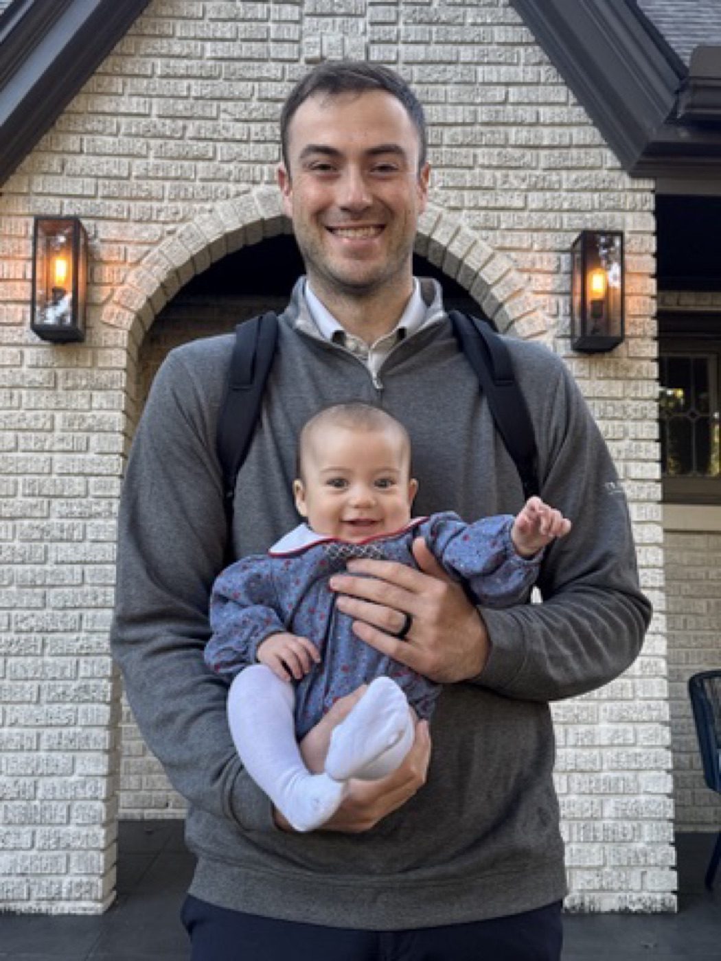 Man cradling a smiling baby, warm connection