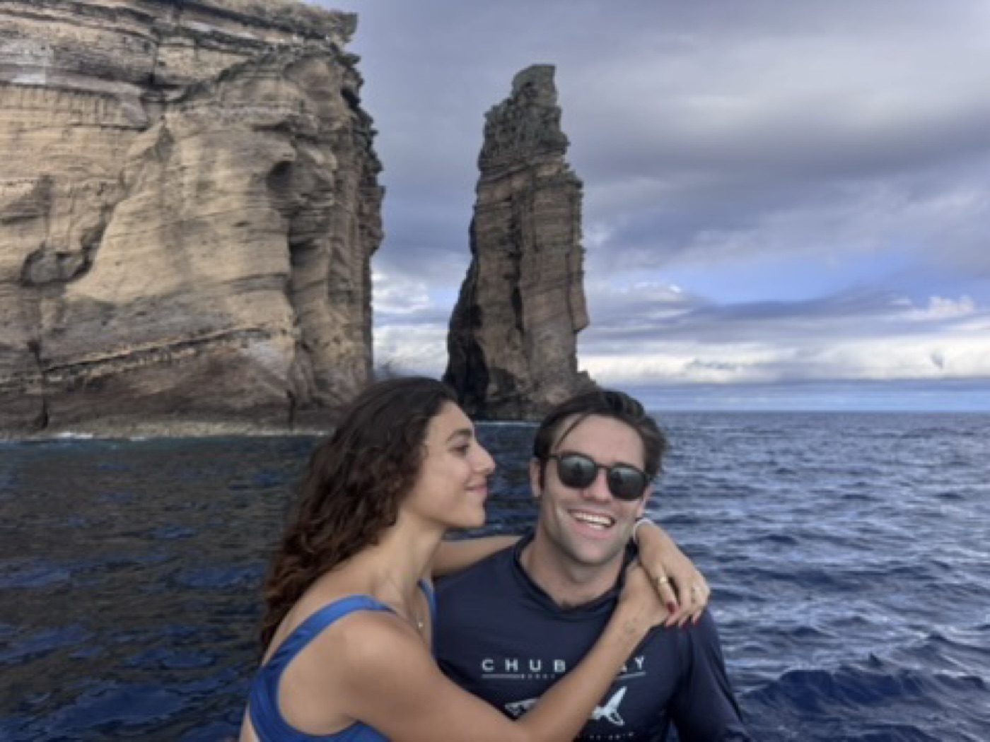 Intimate boat shot beneath a dramatic sea stack
