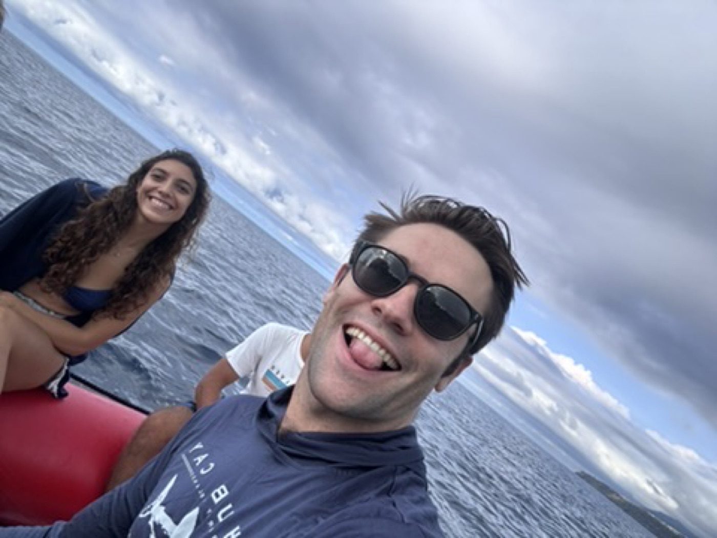 Playful tongue-out boat selfie