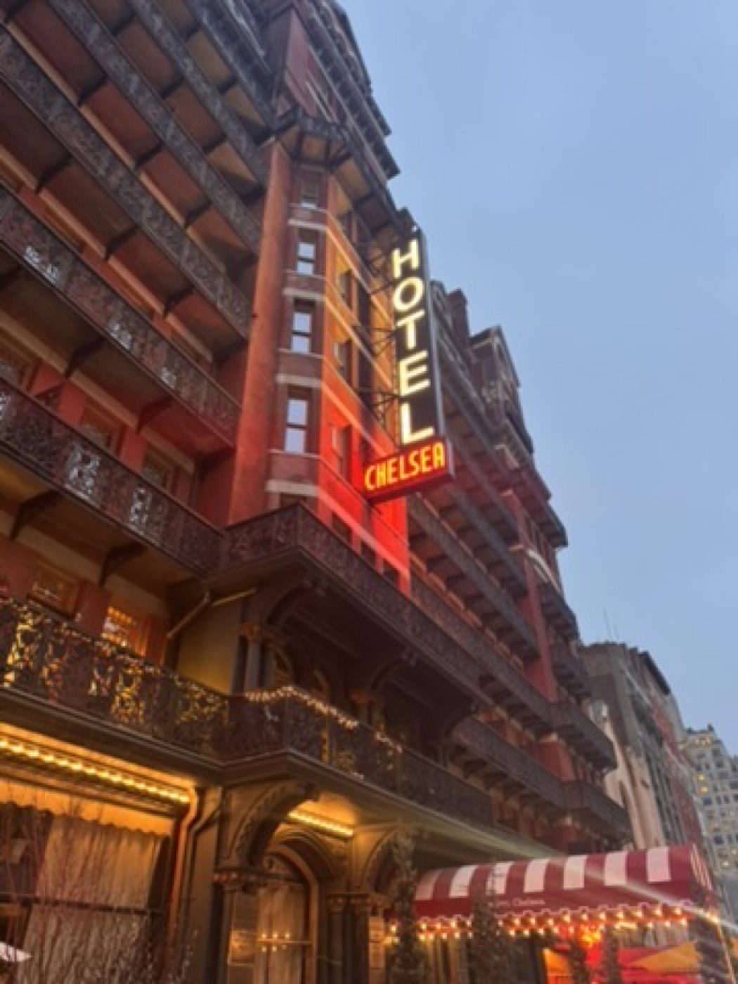 Glowing Hotel Chelsea neon sign at blue-hour dusk