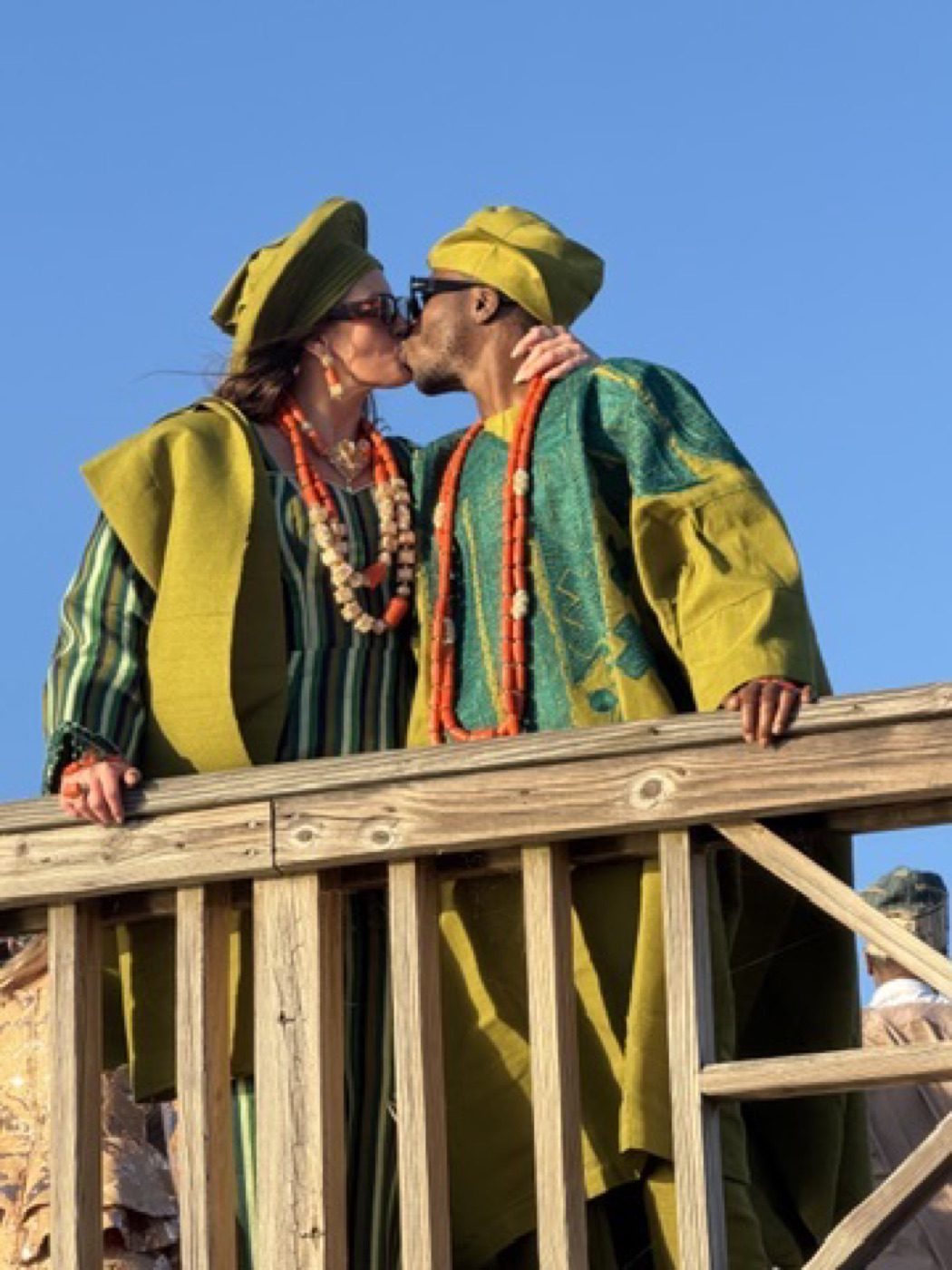 Couple in green Yoruba dress, warm kiss