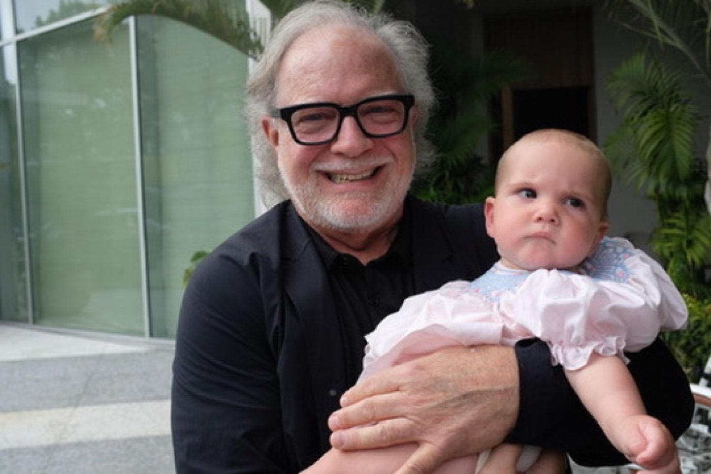 Grandfather beaming with an infant