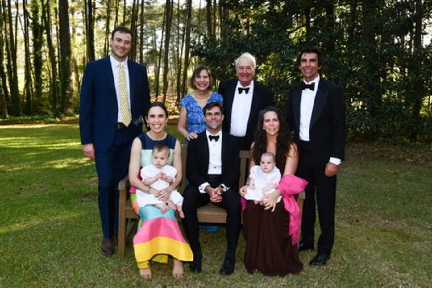 Formal family portrait in the pines, babies on laps