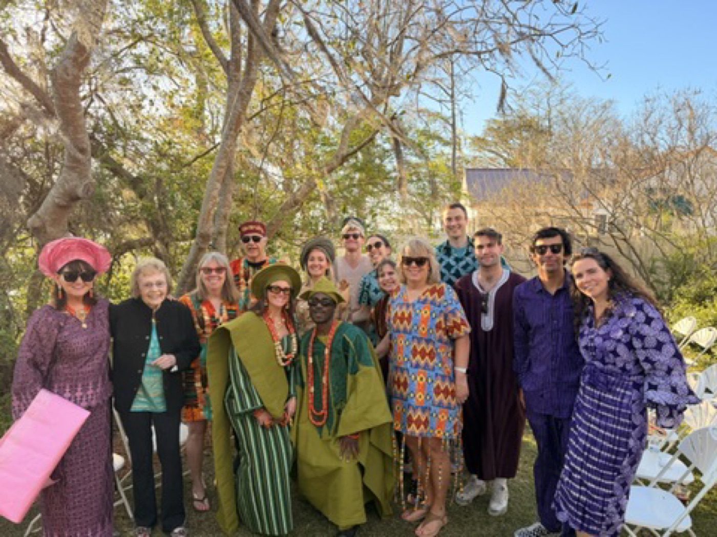 Big joyful group in colorful dress at an outdoor celebration