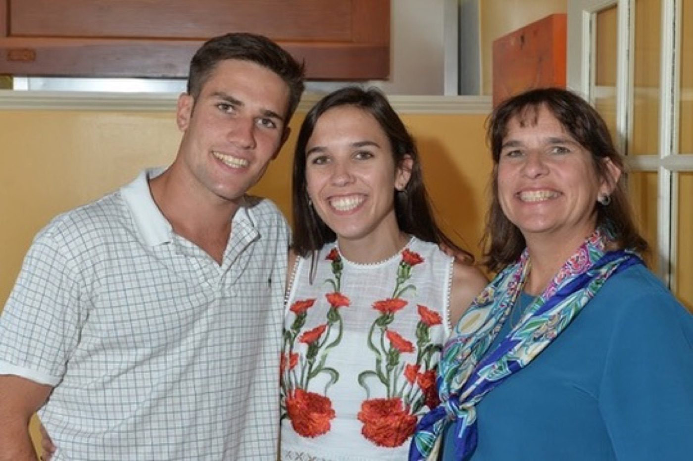 Noel with family, all smiles at a summer gathering