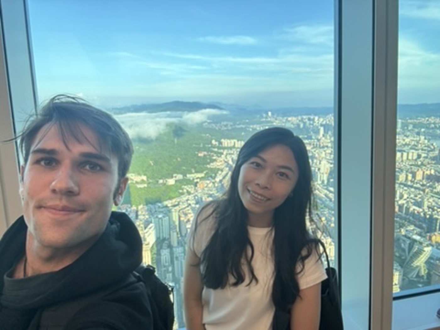 Noel and his partner beaming atop Taipei 101