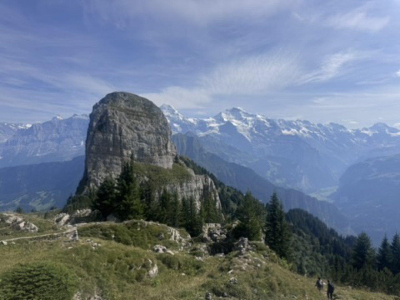 Dramatic rock tower against the layered Alps