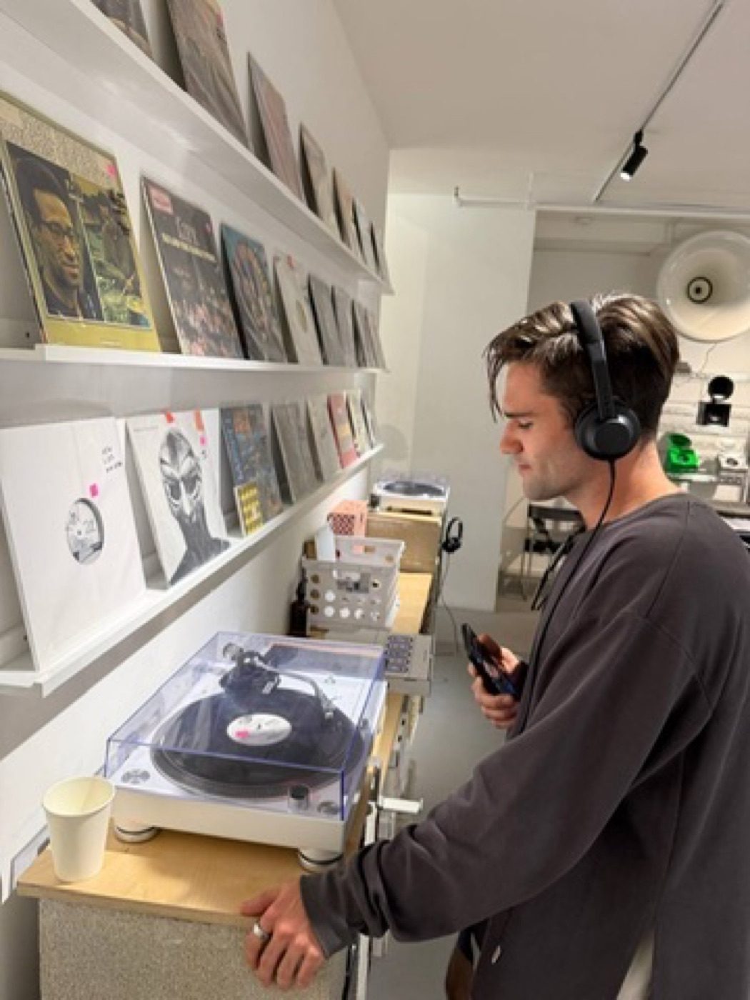 Man browsing records with headphones in a vinyl shop