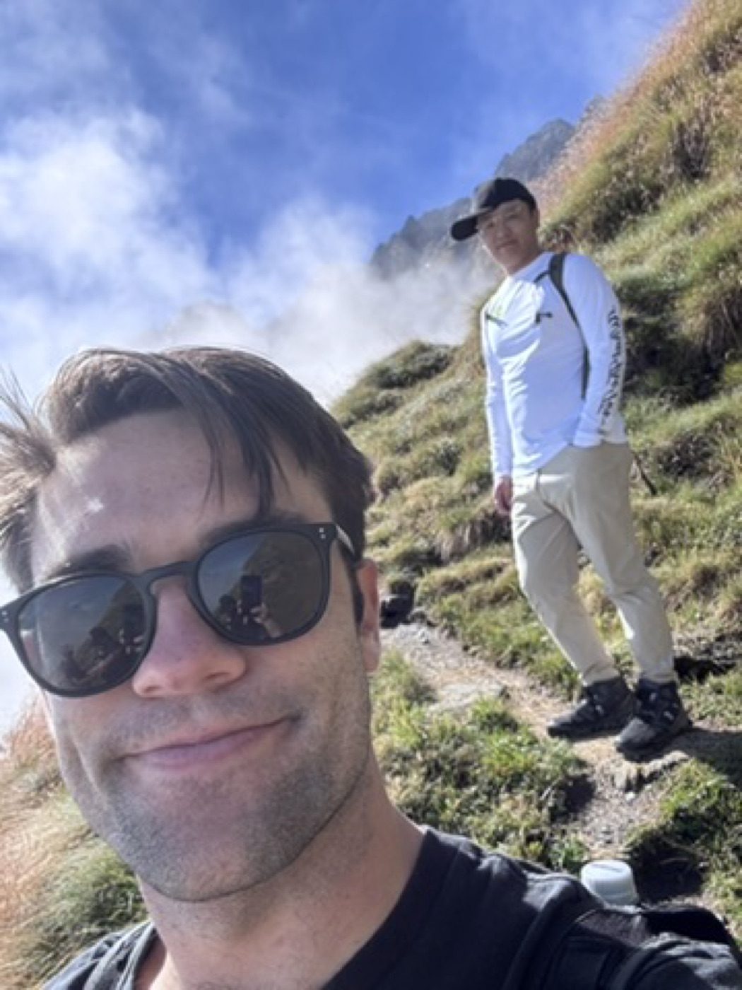 Trailside selfie with a buddy on a misty climb