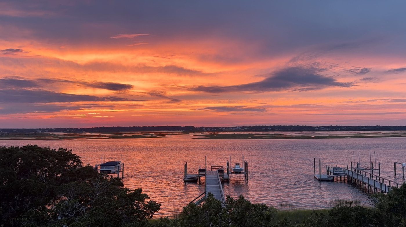 Dramatic marsh sunset, vivid sky over docks