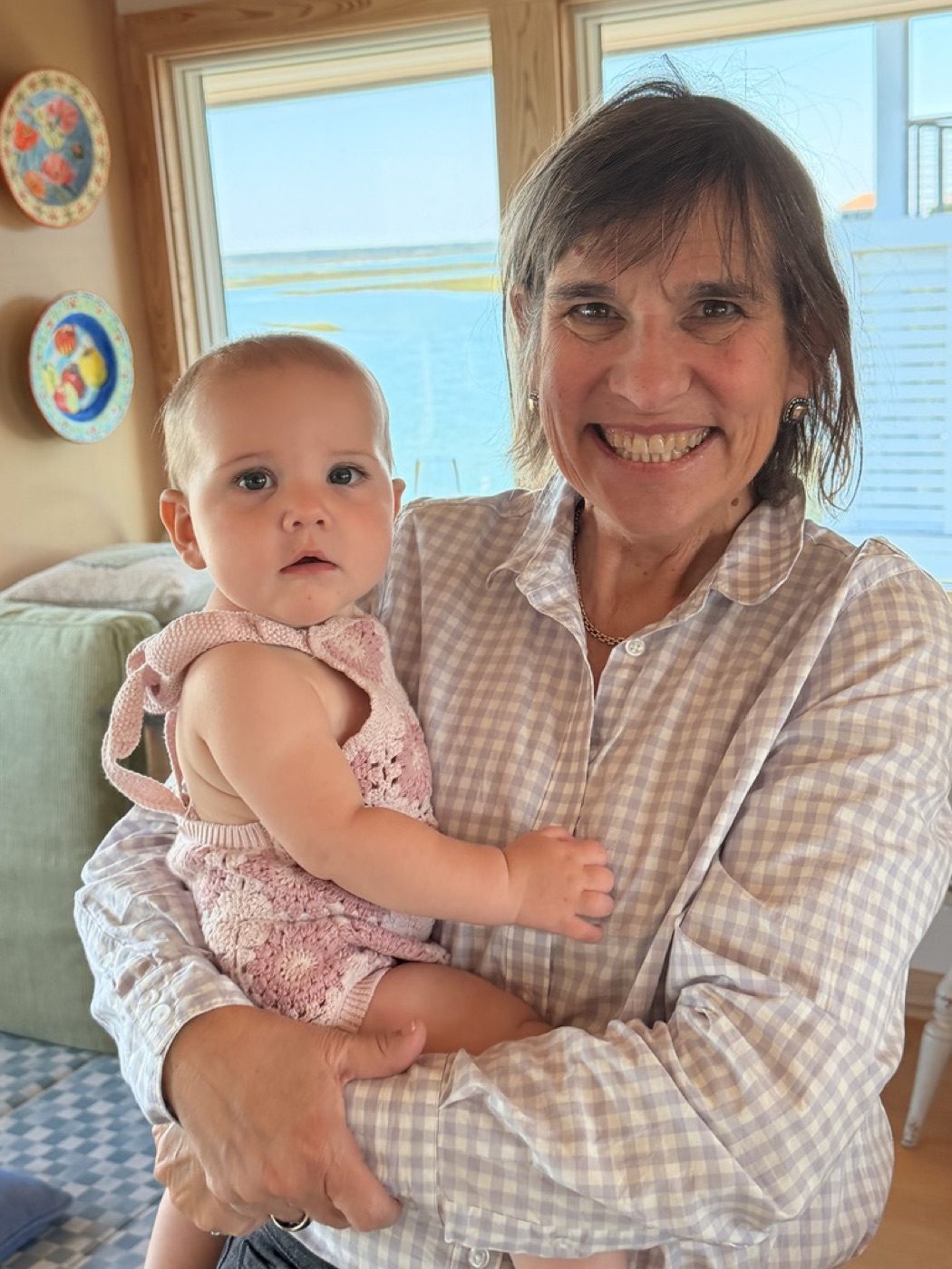 Grandmother and baby by a window, tender expression