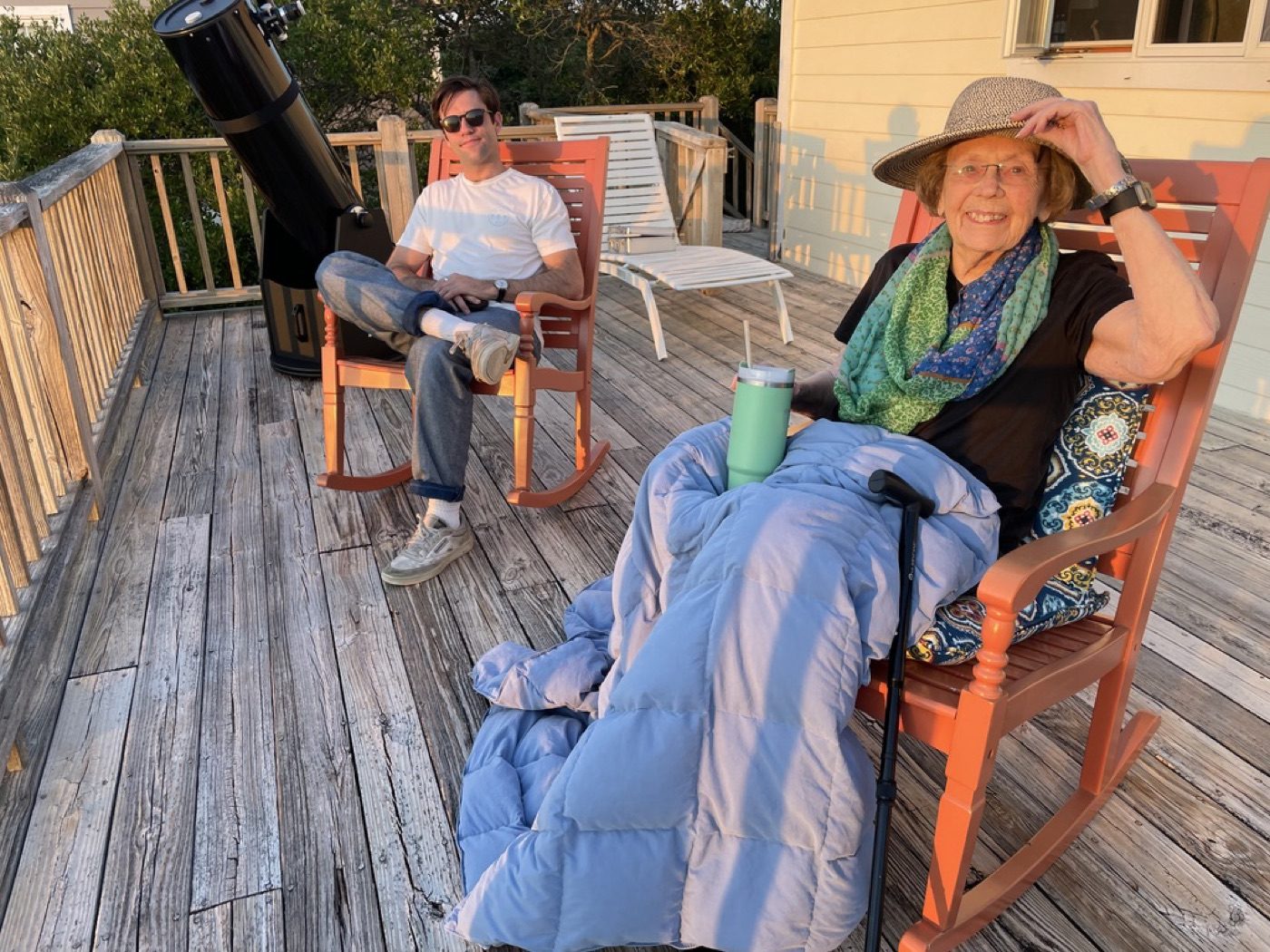 Golden-hour porch scene with a telescope