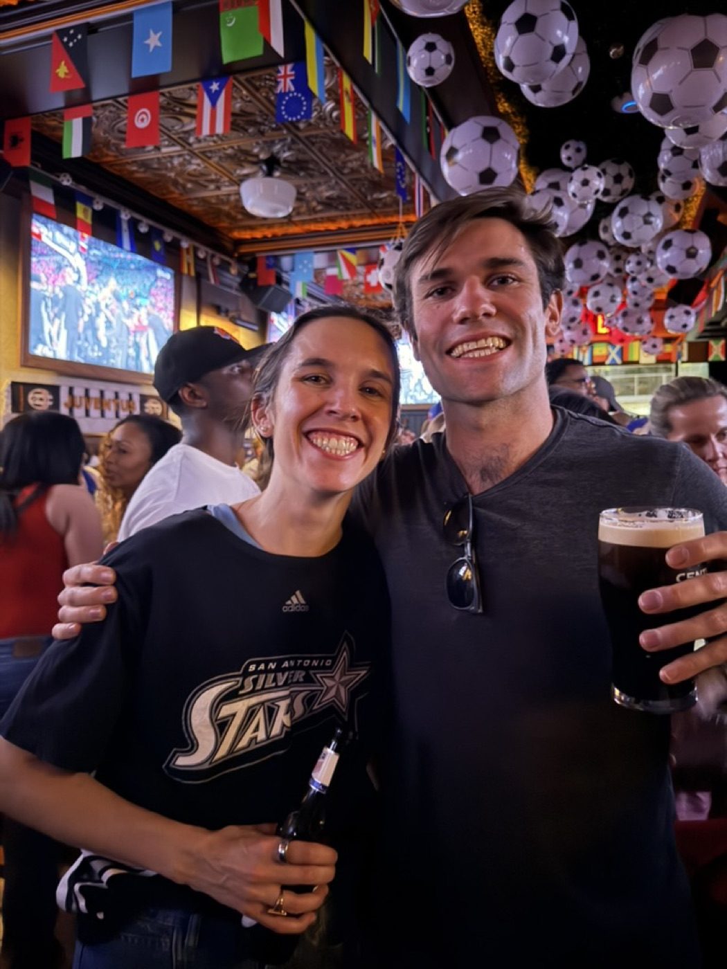 Cheek-to-cheek with his partner, beaming at the soccer bar