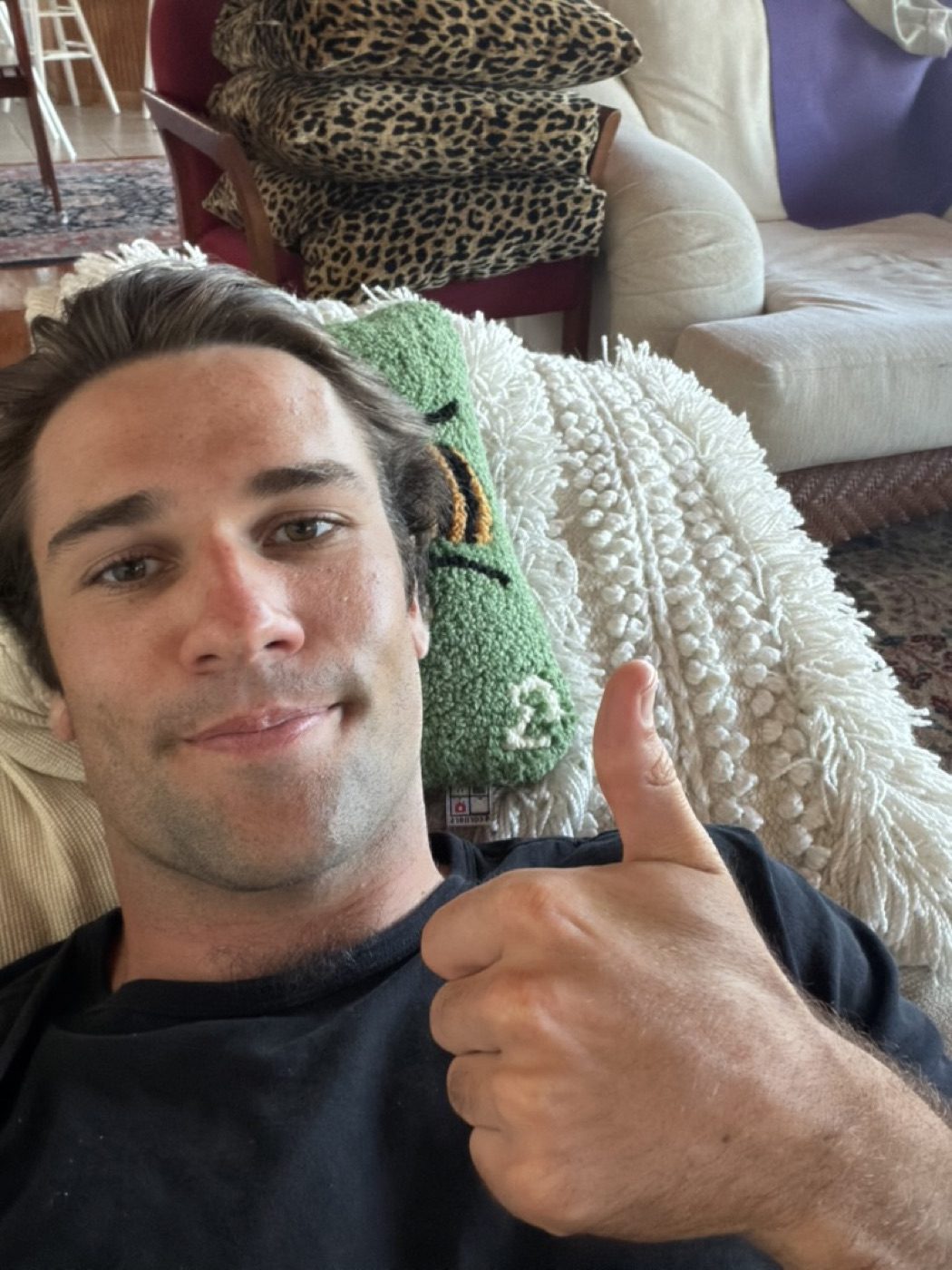 Cozy couch thumbs-up selfie, easy afternoon at home