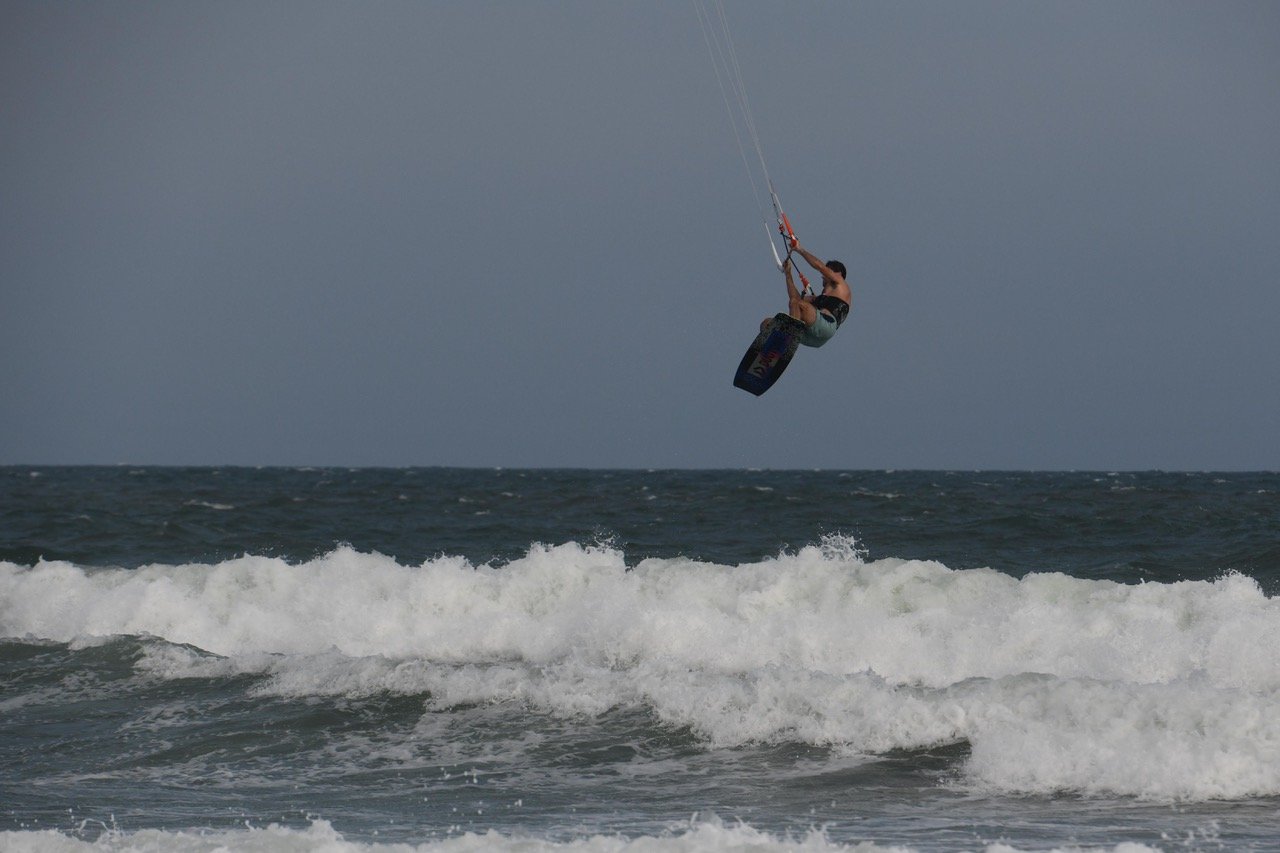 Big air off the lip, board grabbed, whitewater below