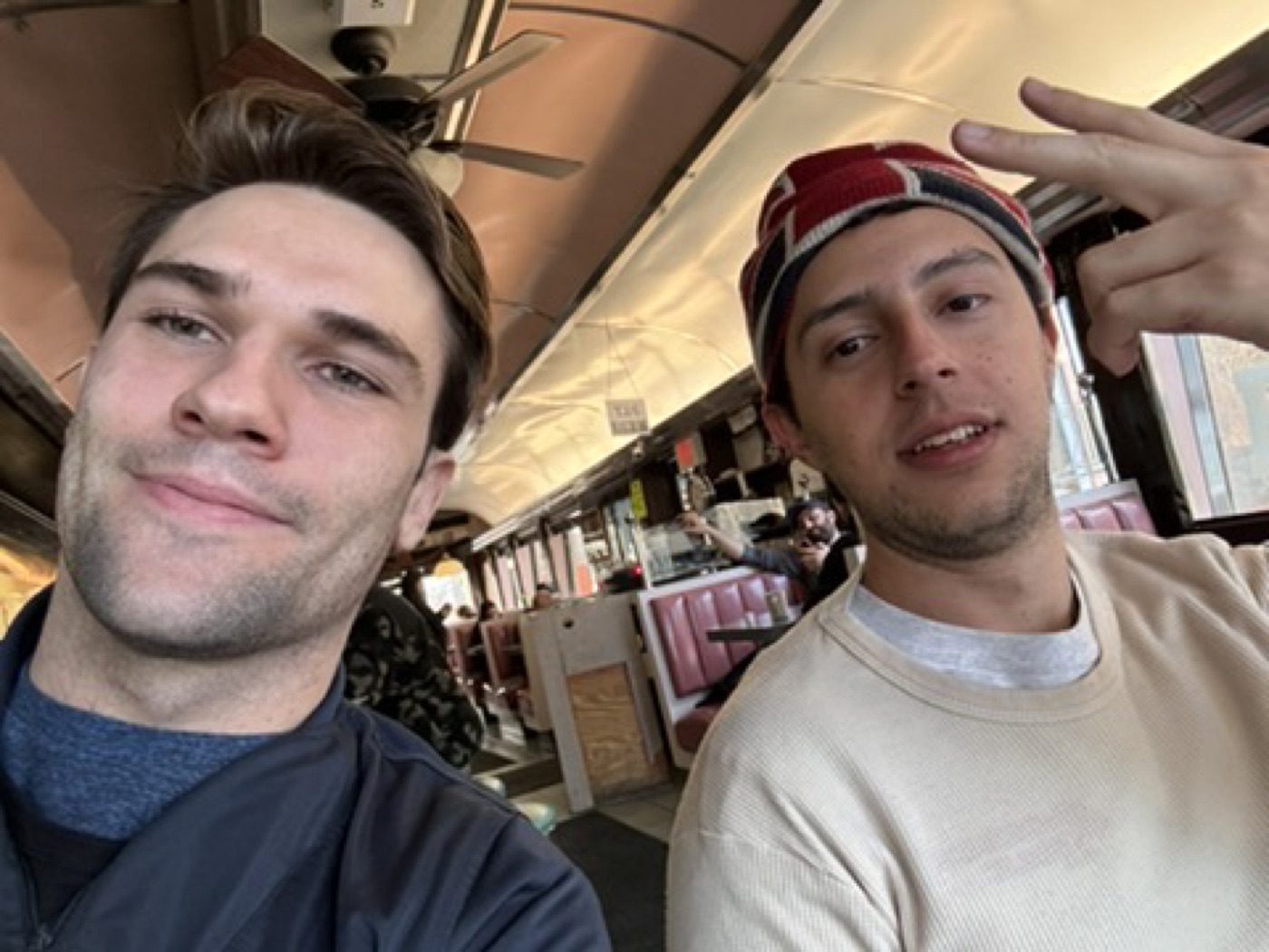 Goofing with a friend in a retro diner booth
