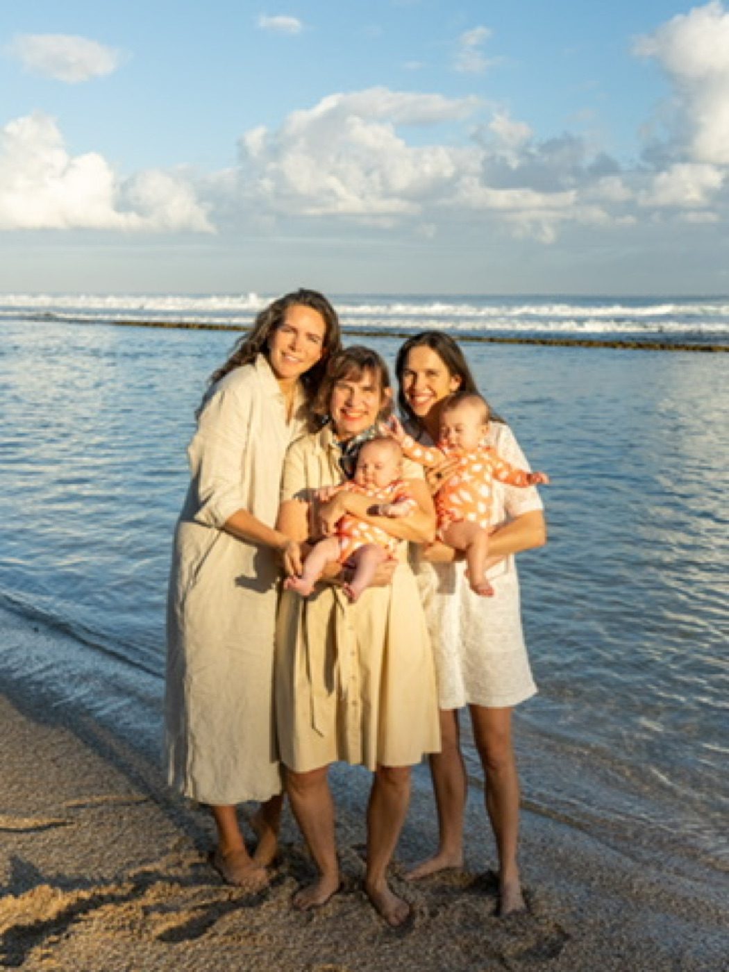 Two mothers and babies on a golden beach