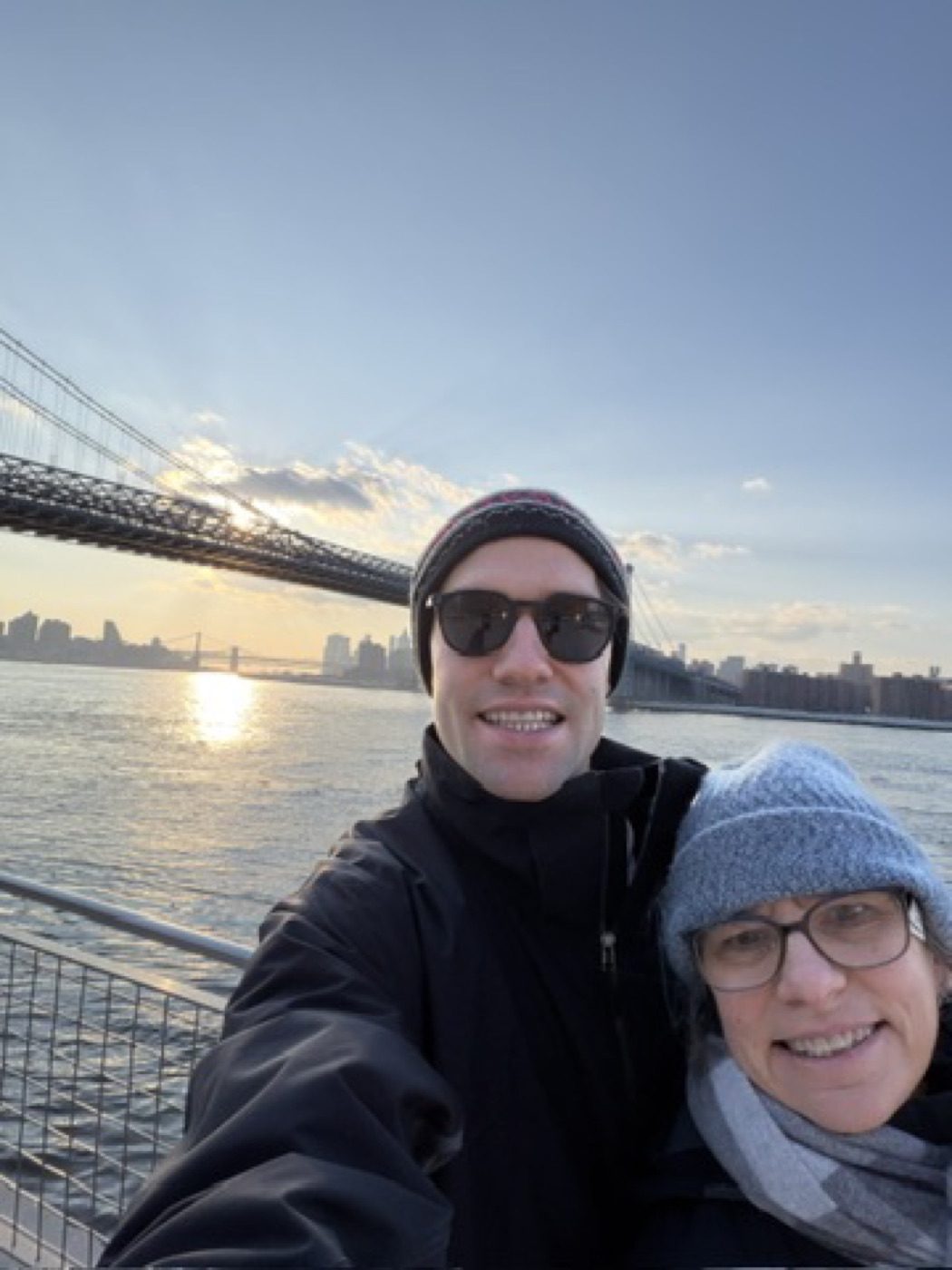 Bundled winter selfie with mom under the Williamsburg Bridge